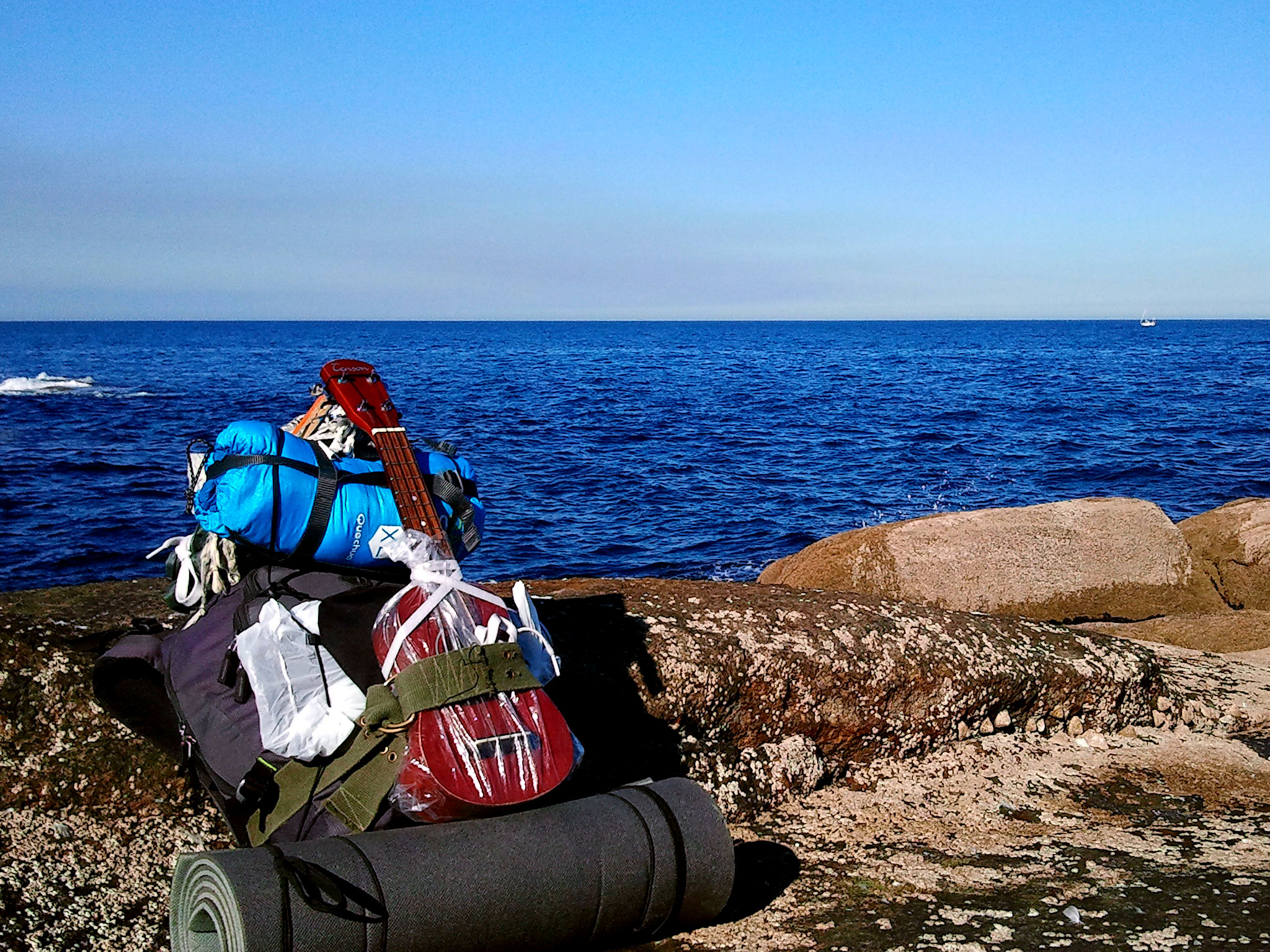 My backpack in front of the ocean of Muxía